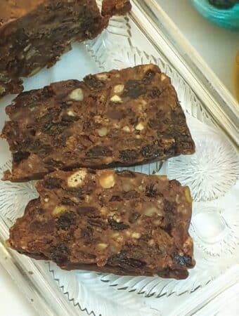 Two slices of no-bake Christmas cake on a glass tray, showing the texture of the cake.