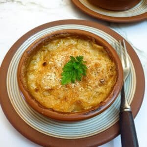 Close up of a dish of prawn and scallop au gratin.