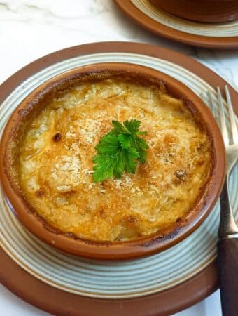 Close up of a dish of prawn and scallop au gratin.