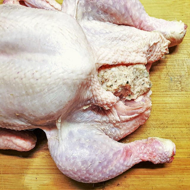 Pork sausage sage and onion stuffing inside the neck cavity of a chicken.