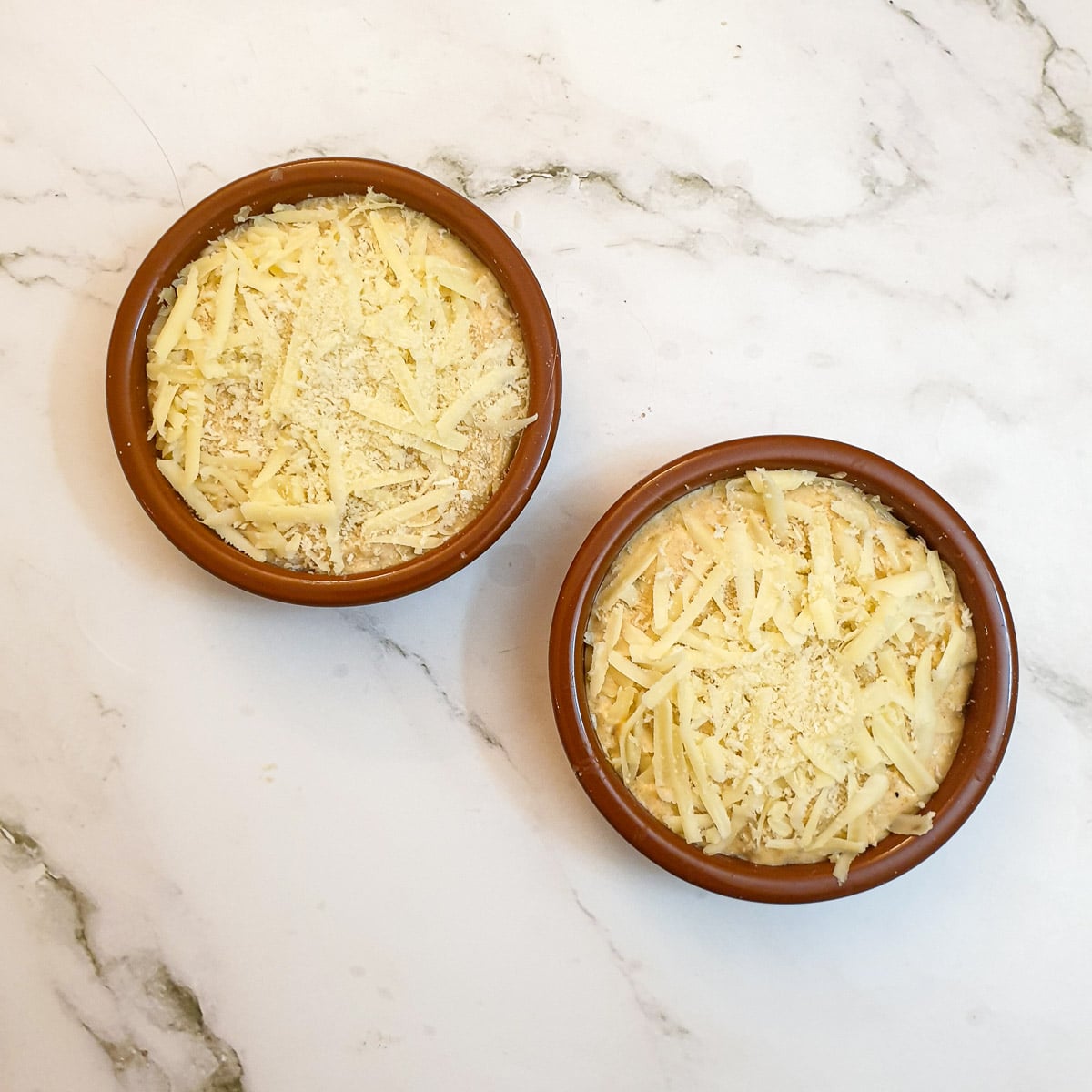 Prawns and scallops covered in sauce and topped with grated cheese.