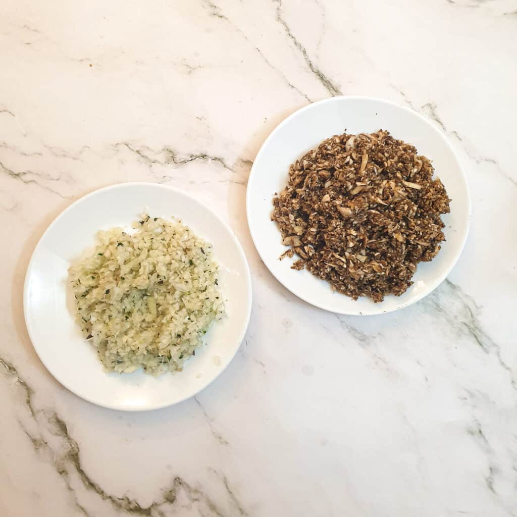 A plate of chopped mushrooms and a plate of chopped onions.