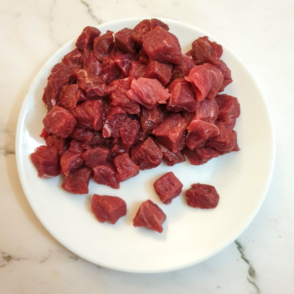 Finely diced stewing steak on a plate.