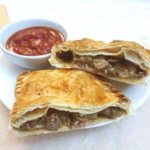 A steak and onion bake cut in half to show the filling.