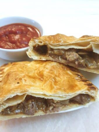 A steak and onion bake cut in half to show the filling.