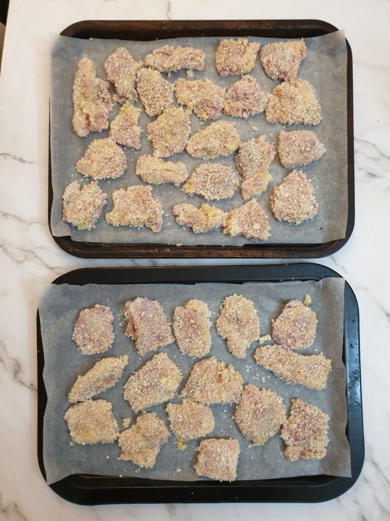 2 trays of crispy chicken ready to go into the oven.