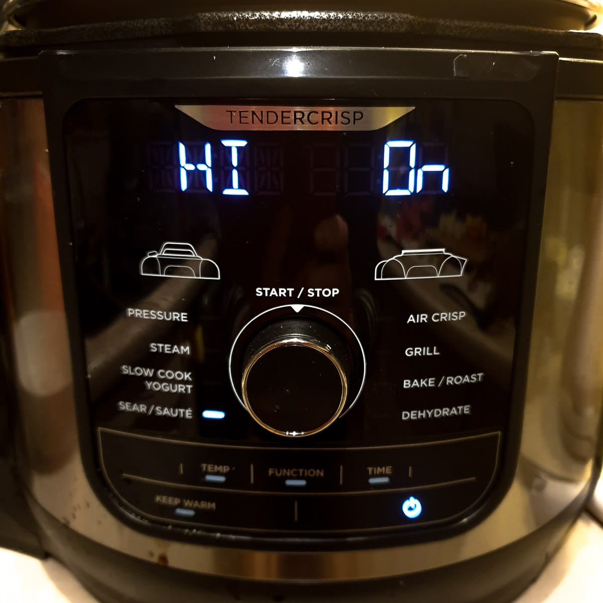 The front of a Ninja pressure cooker showing the saute setting.