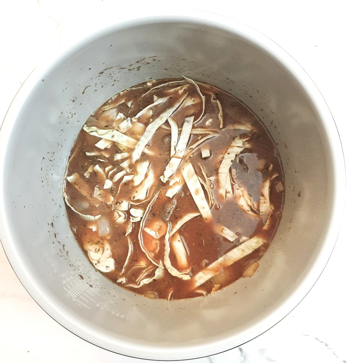 Cabbage and stock added to the beef and onions.