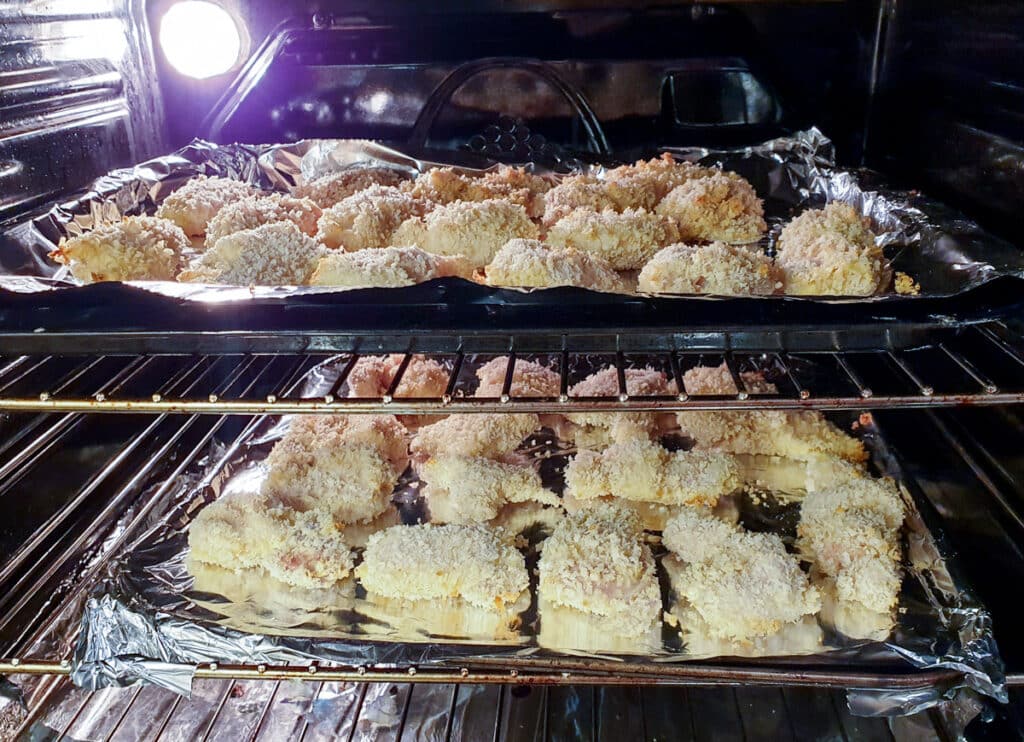 2 trays of crispy chicken in the oven.