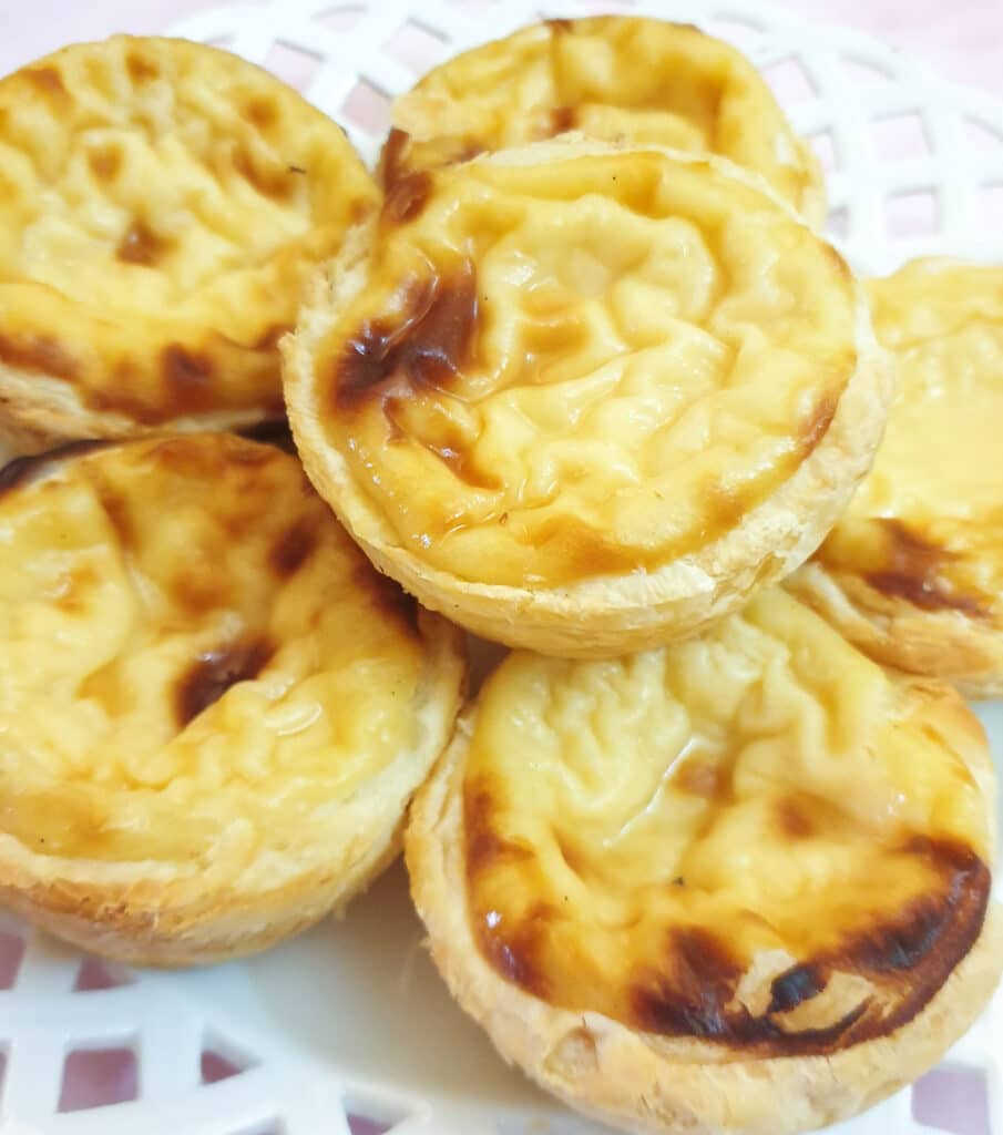 Close up of Portuguese custard tarts on a plate. Close up of Portuguese custard tarts on a plate.