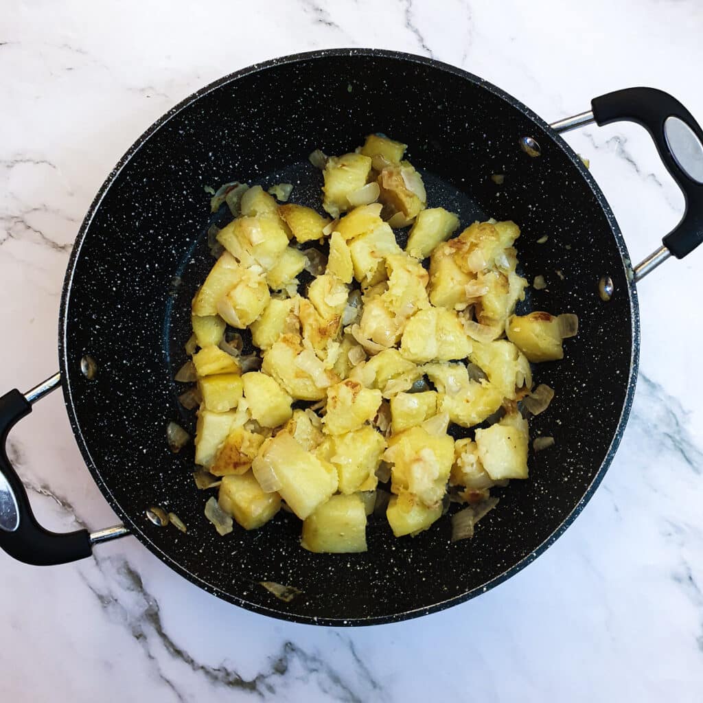 Cooked saute potatoes in a frying pan.