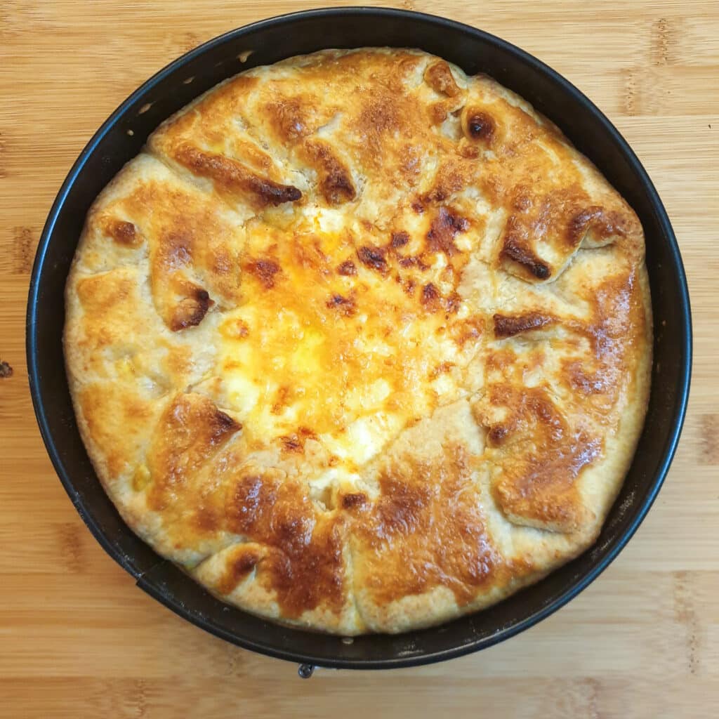 A baked Tex Mex beef pie showing the crispy pastry around the edge and the golden melted cheese in the middle.