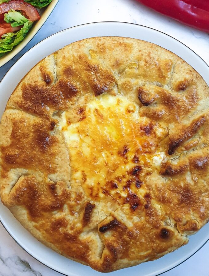 A Tex Mex beef pie showing the crispy pastry around the edge and the golden melted cheese in the middle.