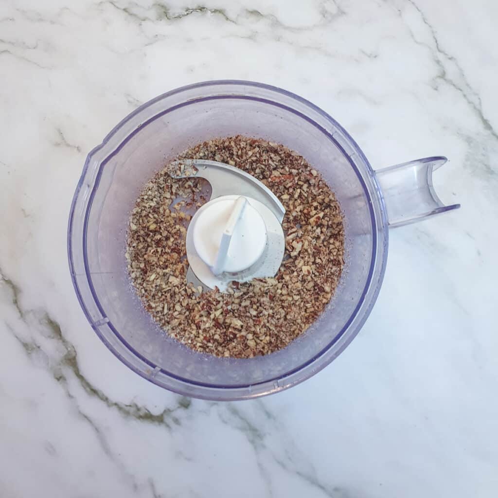 Chopped walnuts in a food processor.