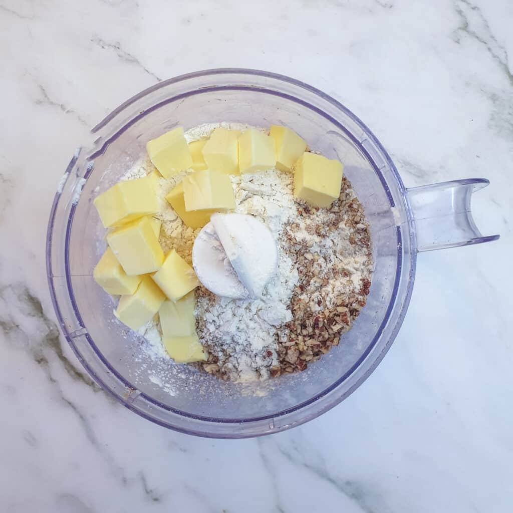 Flour butter and walnuts in a food processor.