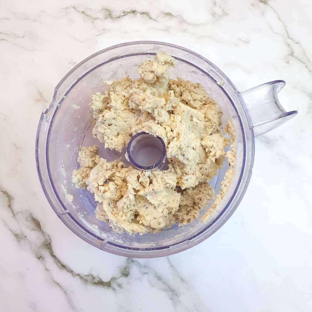 A ball of walnut pastry in a food processor.