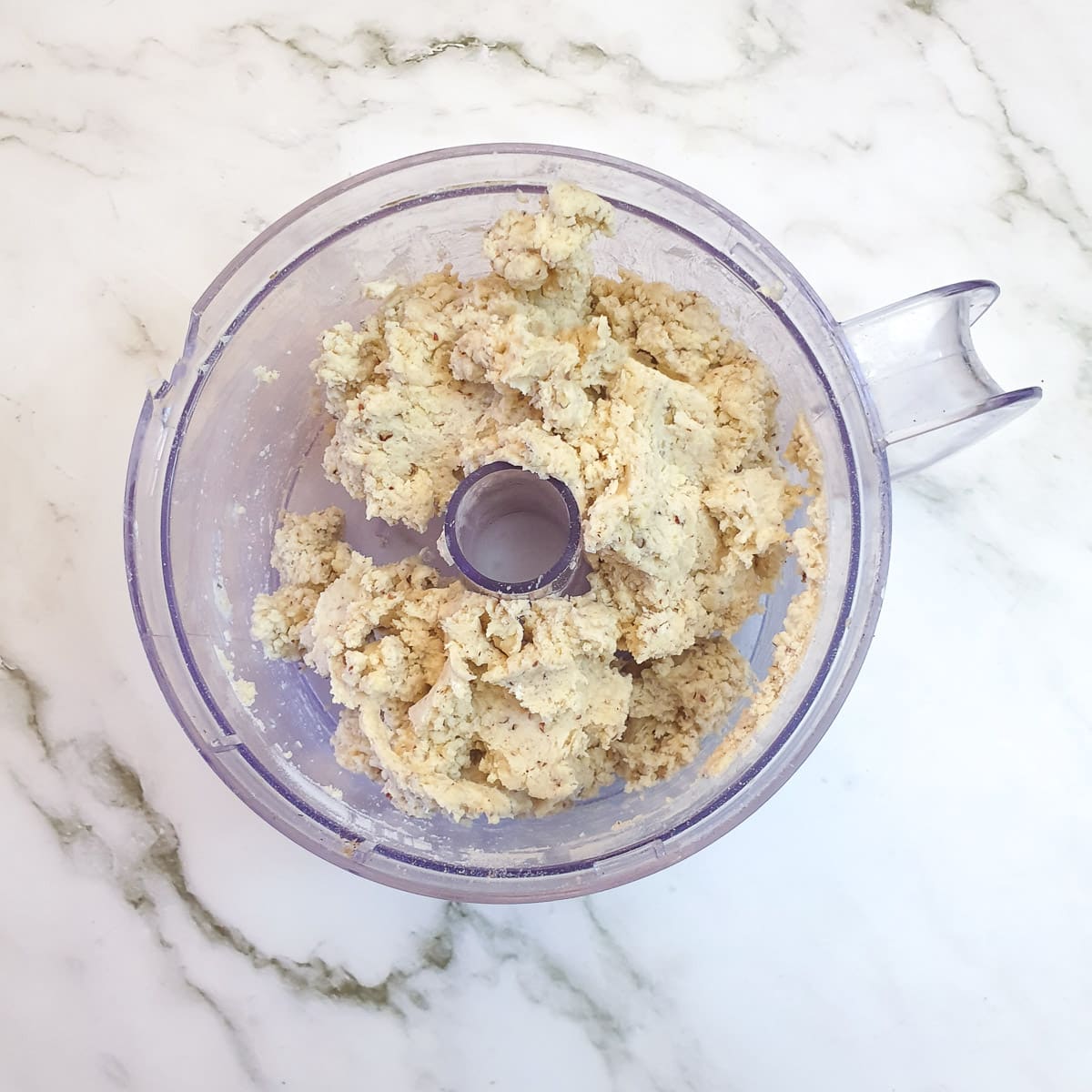 A ball of walnut pastry in a food processor.