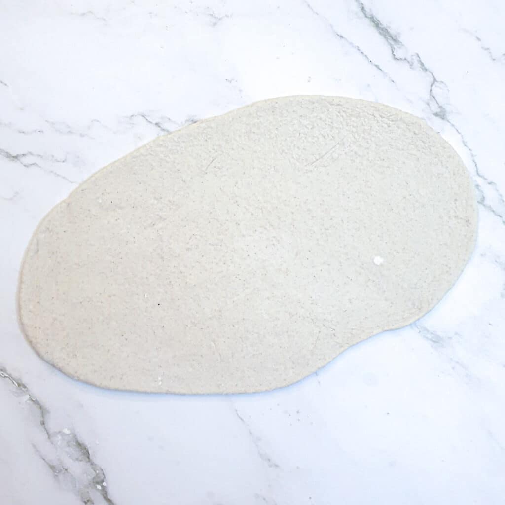 A piece of dough rolled into an oval shape.