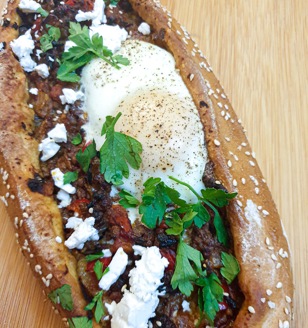 A lamb pide topped with a baked egg.