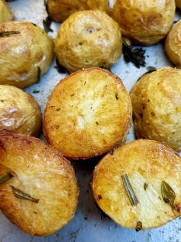 Close up of crispy roast baby potatoes showing the golden brown underside.