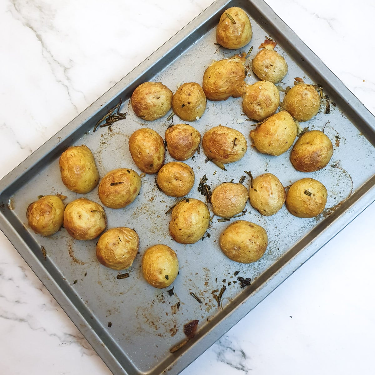 A tray of baked crispy potatoes.