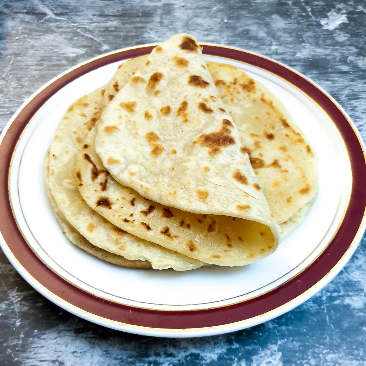 Three flatbreads on a plate.