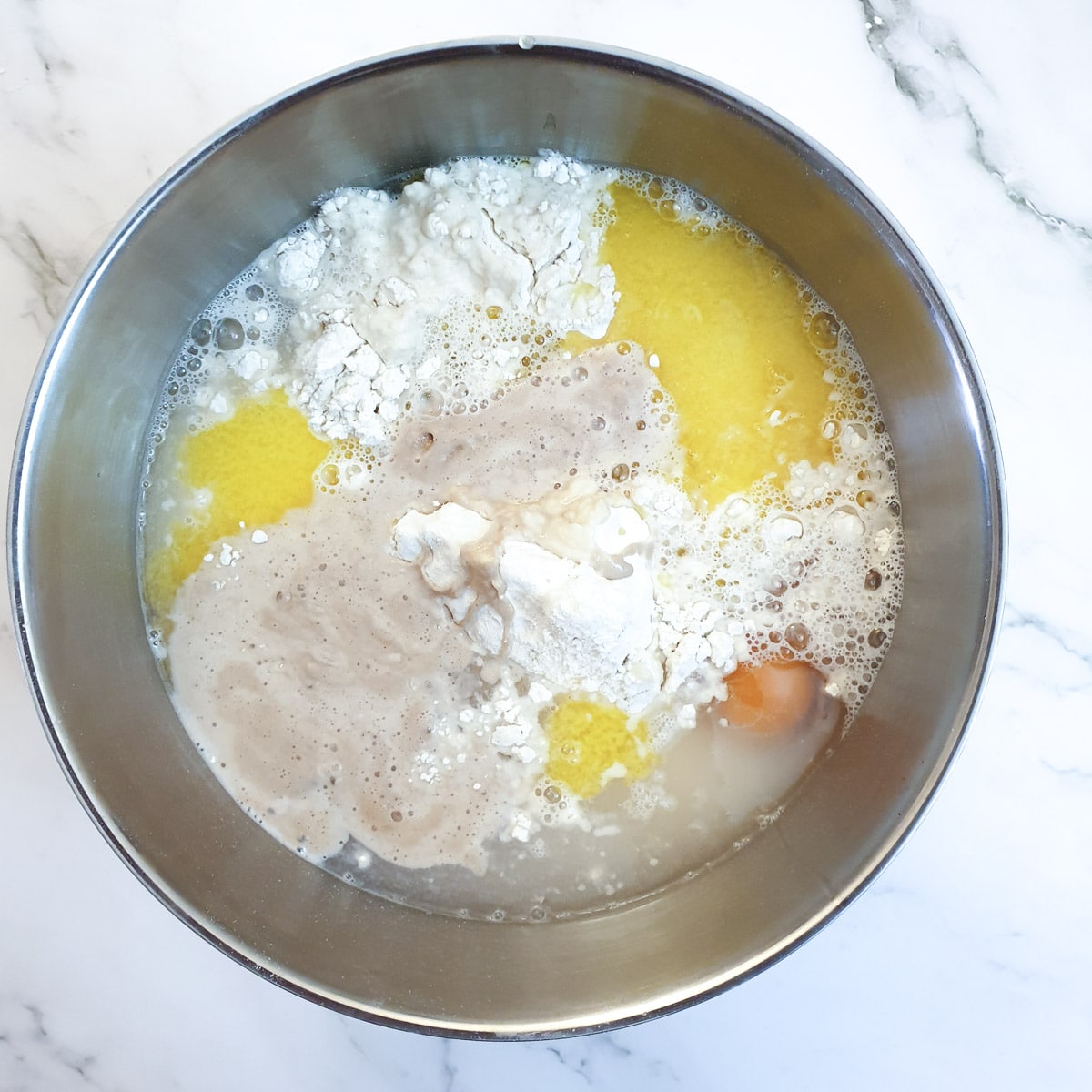 Ingredients for condensed milk rusks in a mixing bowl.