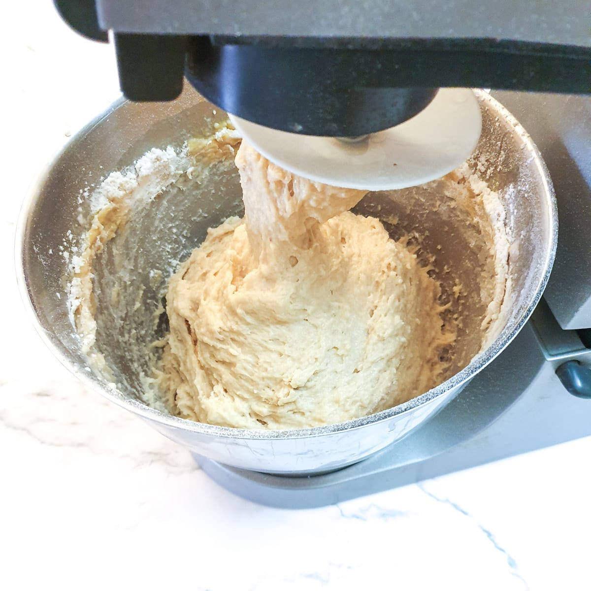 Dough being mixed in a stand mixer.