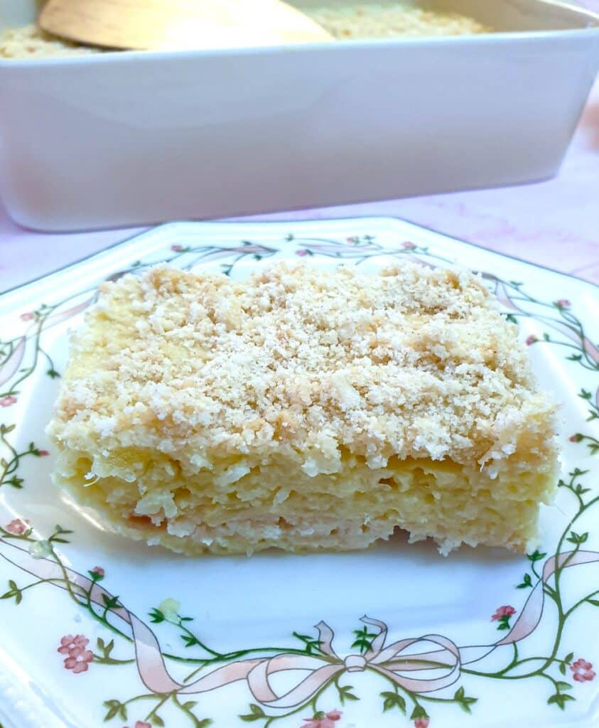 A slice of no-bake pineapple fridge tart on a plate.