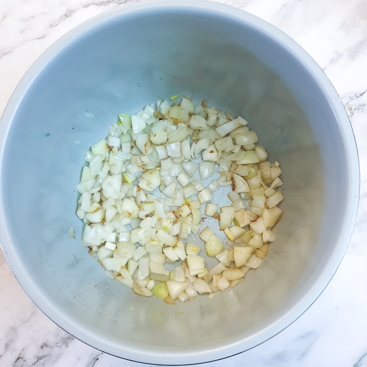 Chopped onions browning in a Ninja multi-cooker.