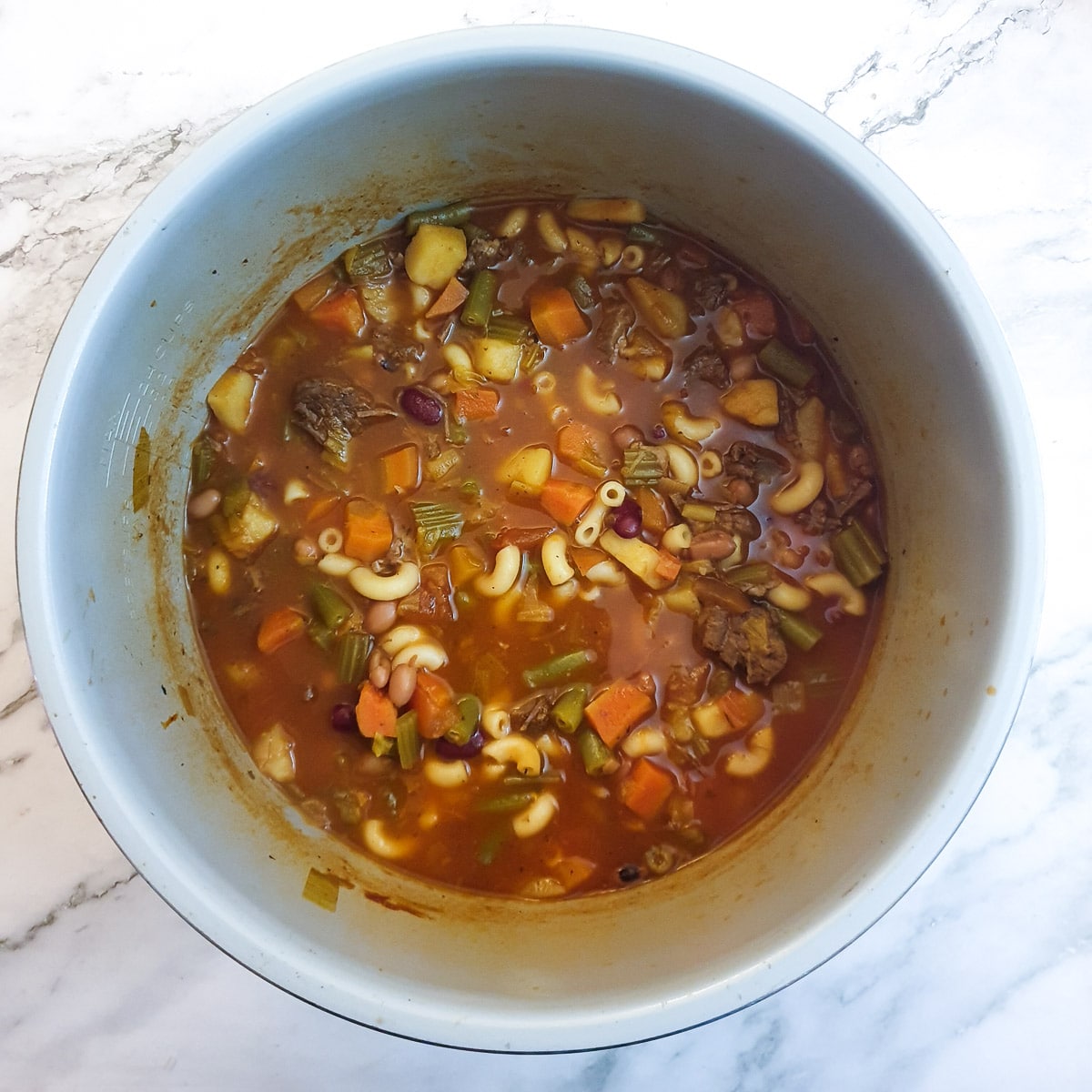 Cooked beef minestrone soup in a pressure cooker.