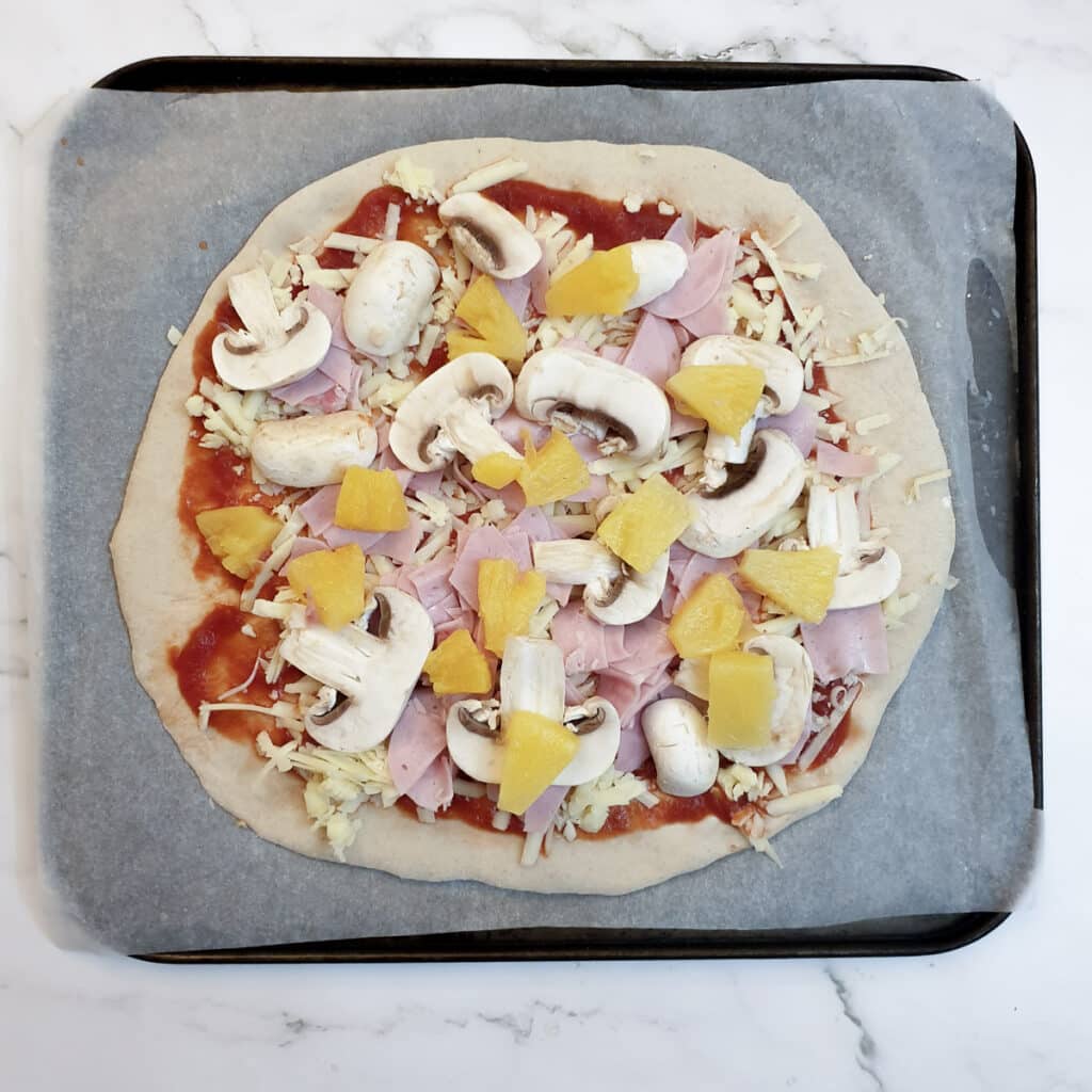 Ham, mushrooms and pineapples added to the pizza.