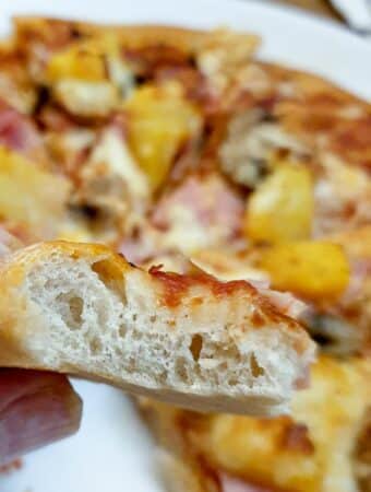 Close up of a cross section of pizza dough.
