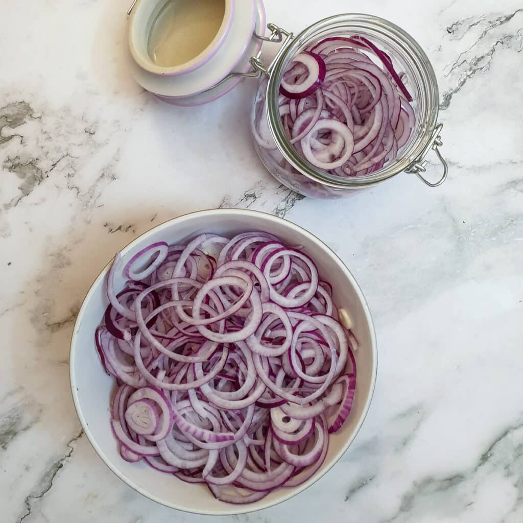 A dish of thinly sliced red onions.