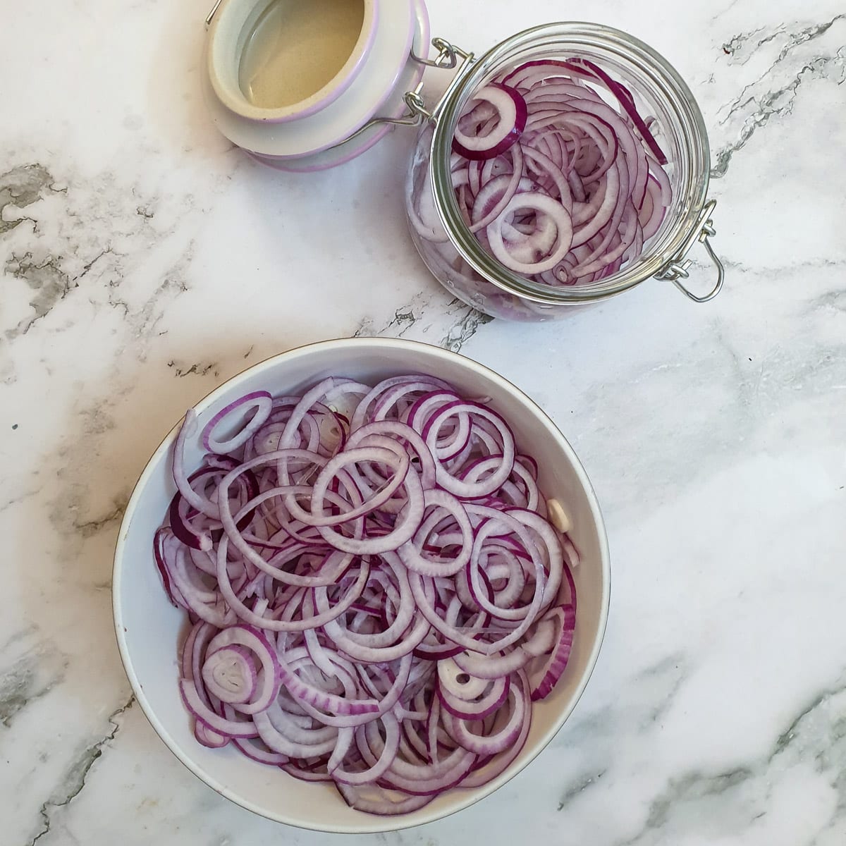 A dish of thinly sliced red onions.