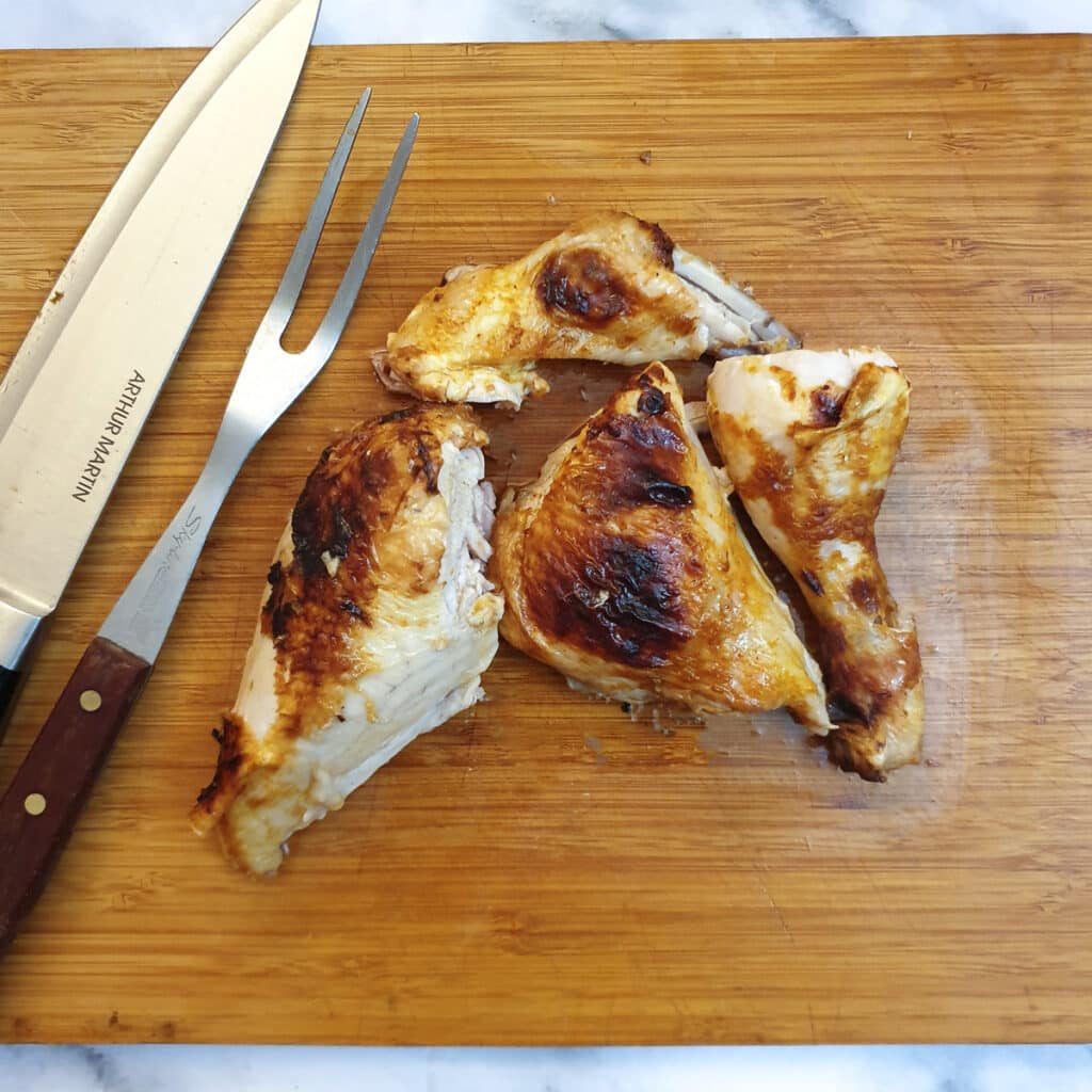 Half a spatchcocked chicken cut into 4 pieces.