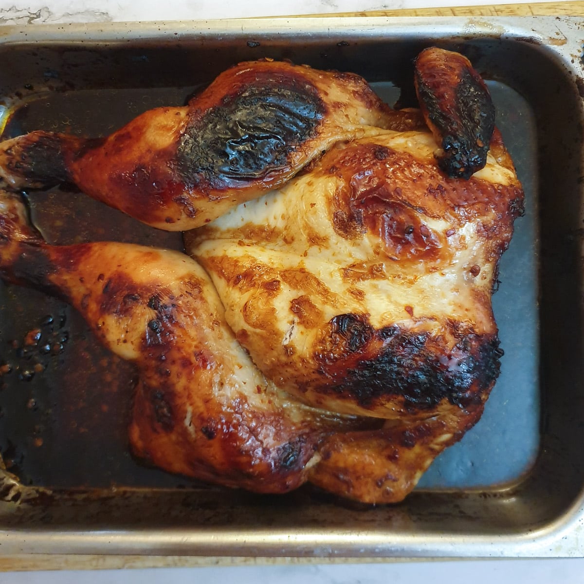 A whole roasted spatchcocked chicken in a honey, chilli and garlic marinade.