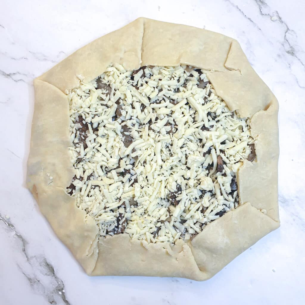 An assembled galette with the edges of the pastry folded up.