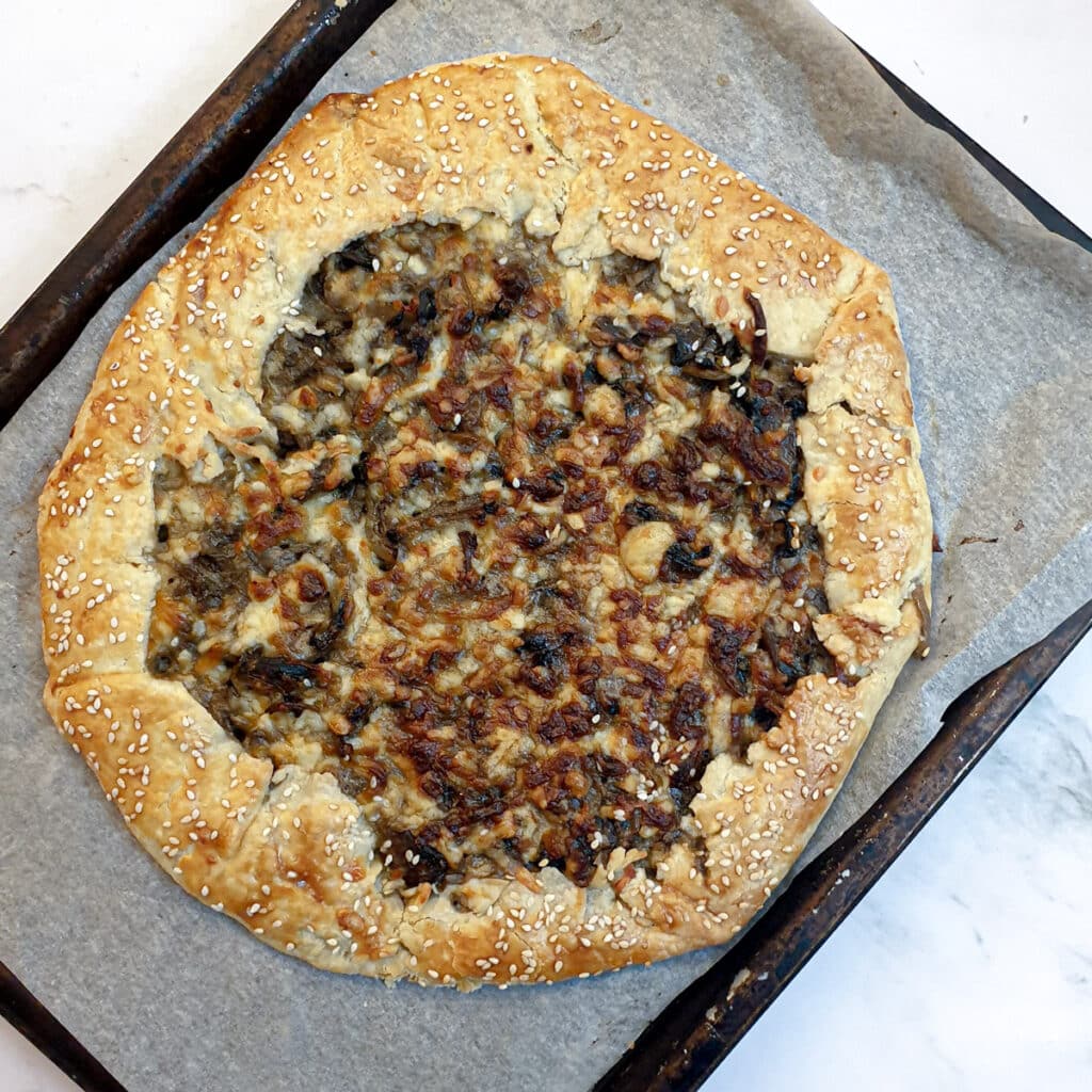 A baked mushroom galette on a baking tray.