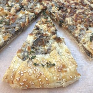 A slice of mushroom galette offset from the main pie.