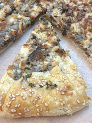 A slice of mushroom galette offset from the main pie.