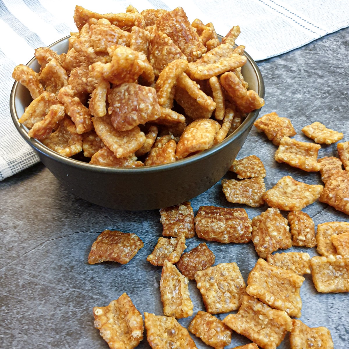 Side on view of a dish of crispy pork scratchings.