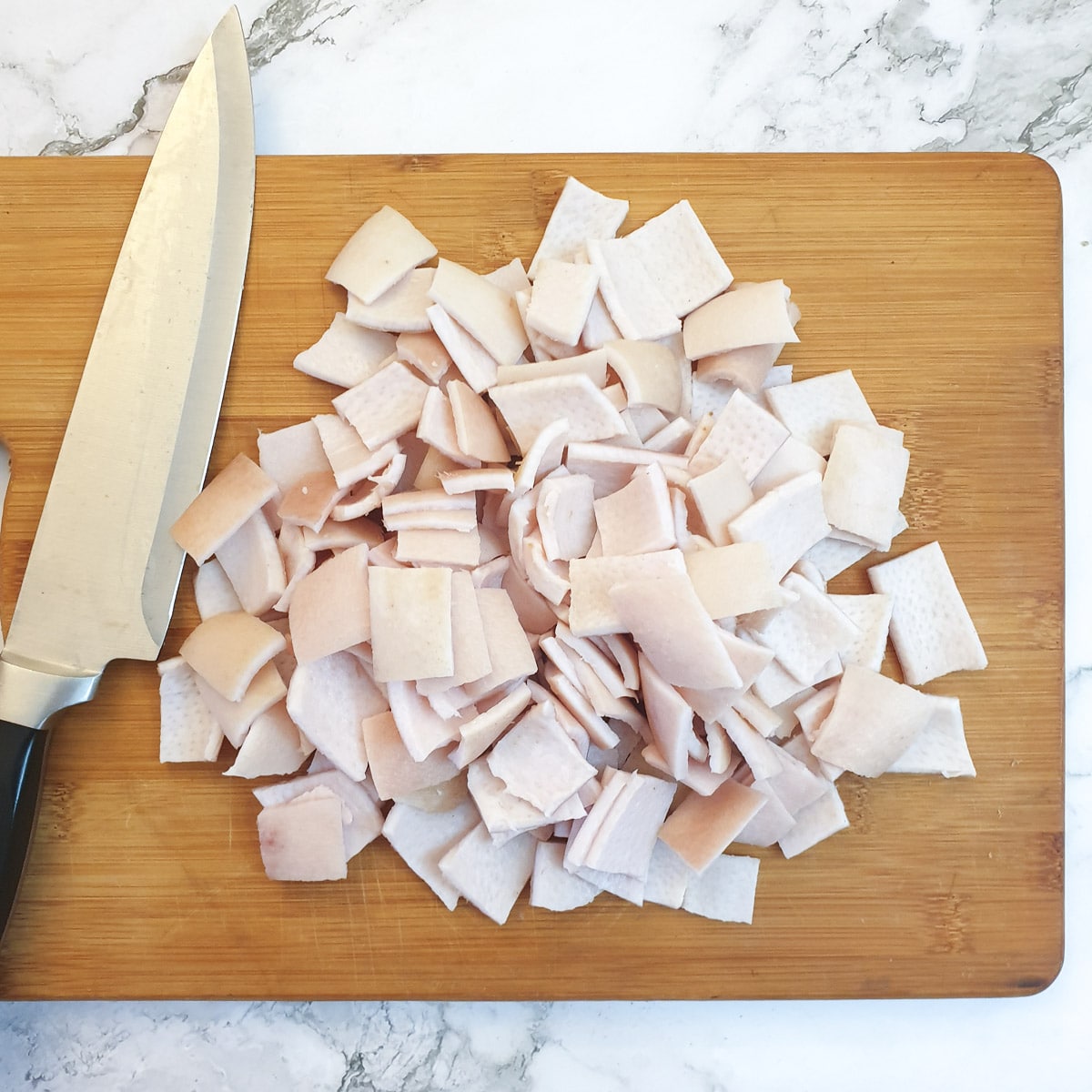 A pile of pork skin cut into squares.