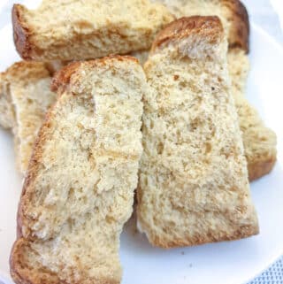 A pile of buttermilk rusks on a white plate.