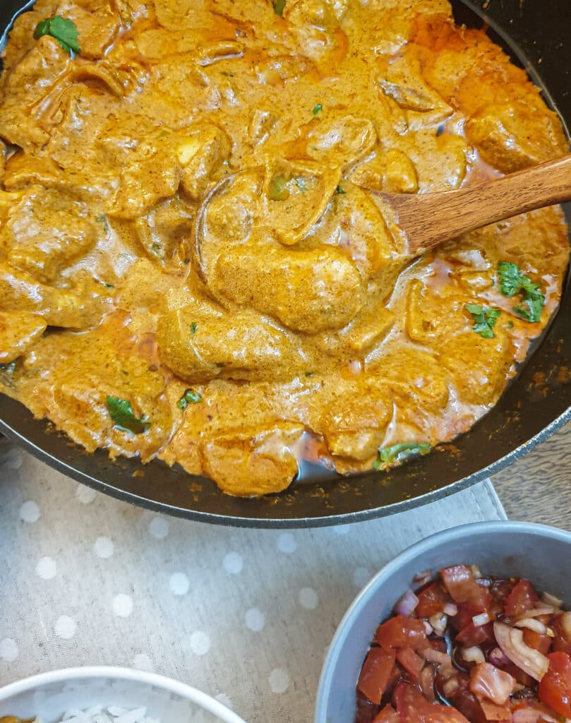 Close up of a dish of butter chicken.