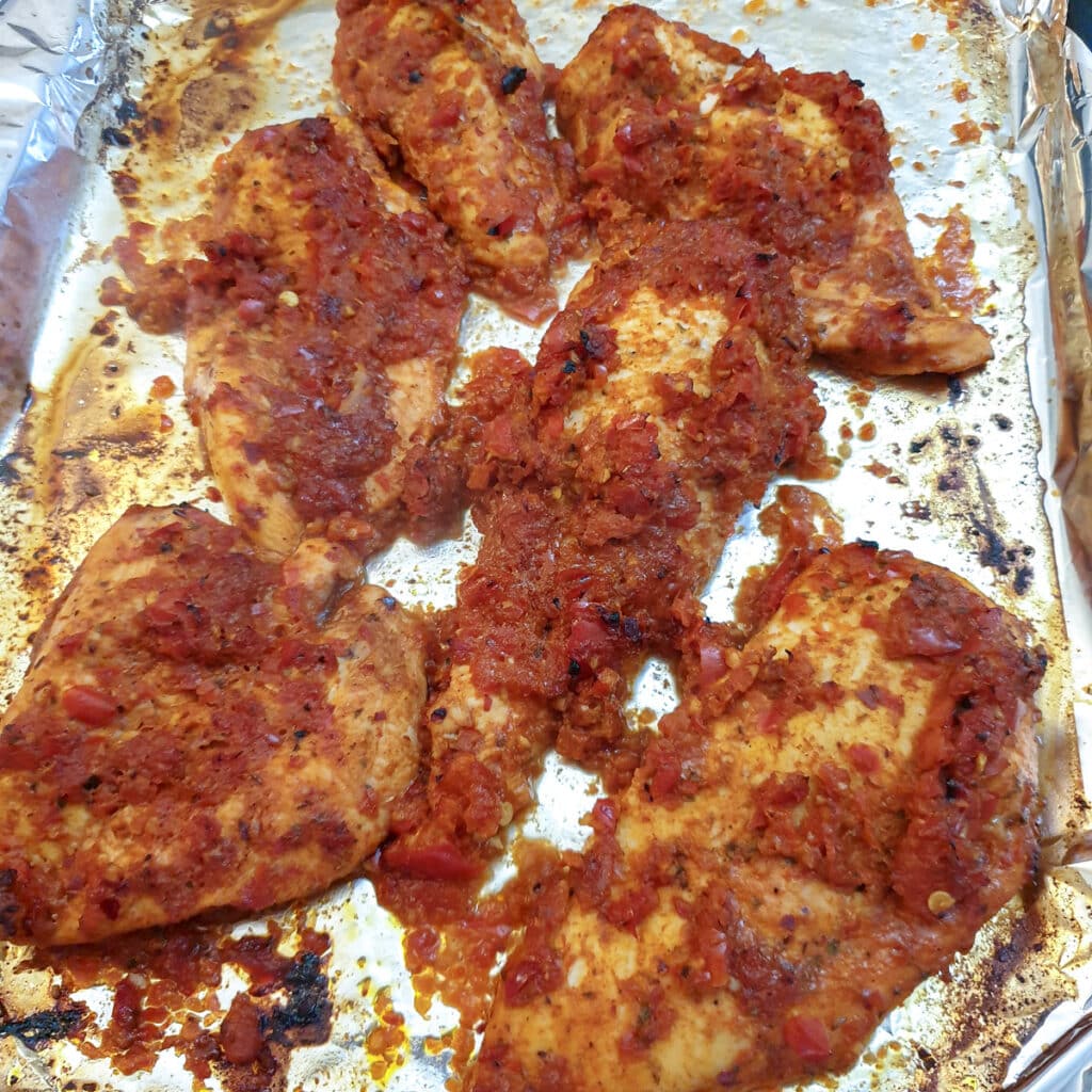 Close up of oven-baked peri peri chicken.