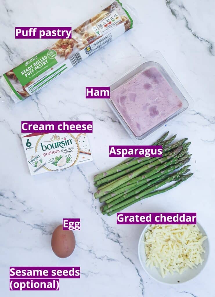 Ingredients for puff pastry asparagus and ham wraps with cheese.