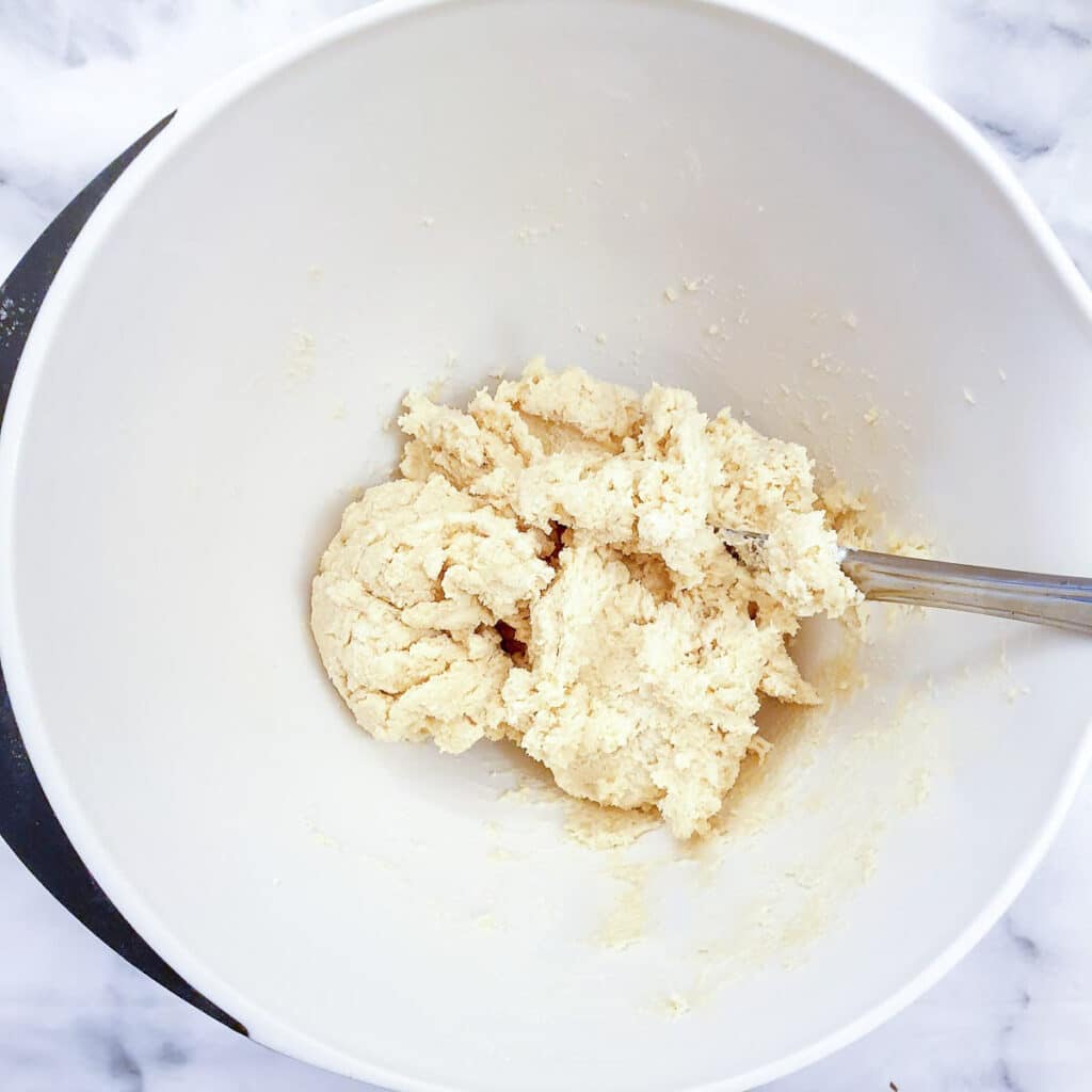 Yoghurt and egg mixed into the flour and butter breadcrumbs to form a shaggy dough.