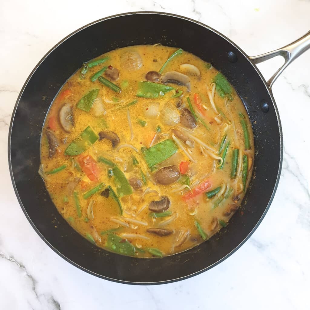 A pan of Thai red curry ready for the seafood to be added.