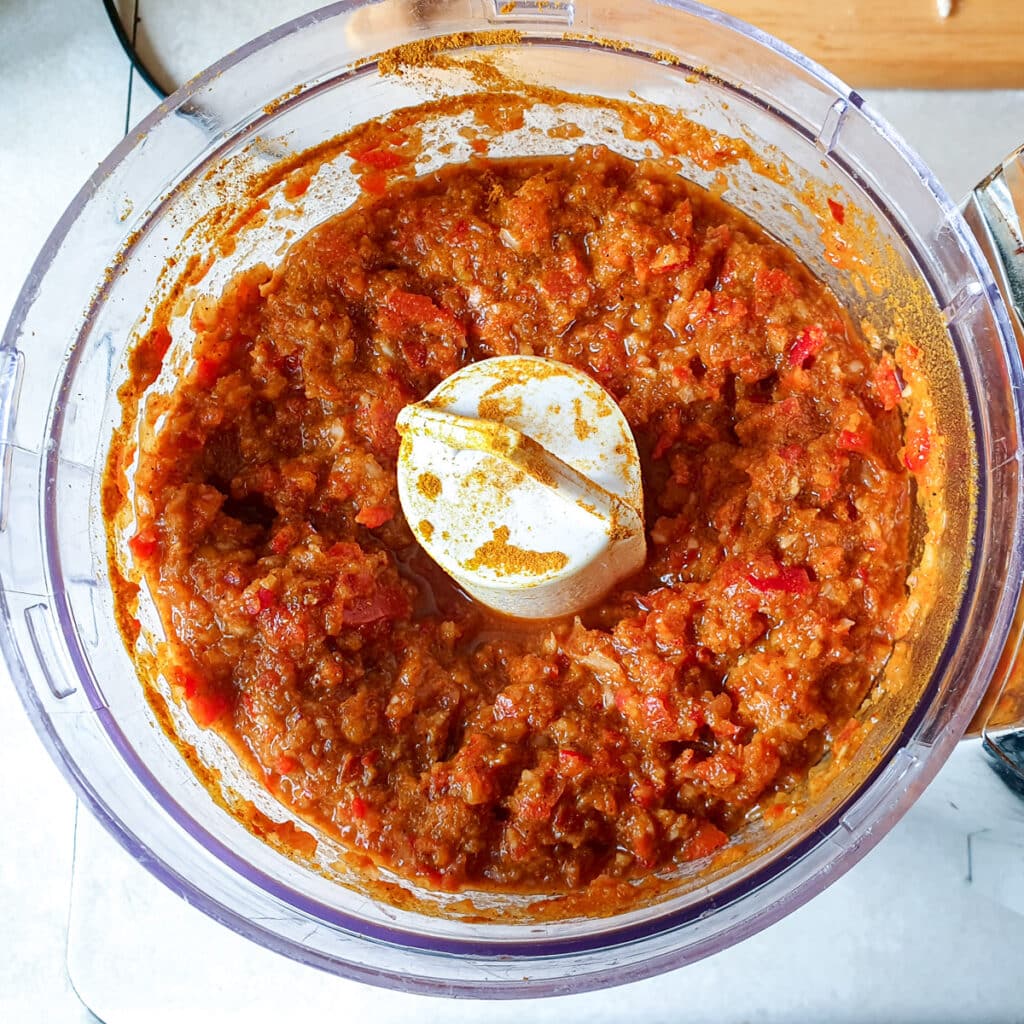 Red peppers and onions blended to a paste with spices in a food processor.